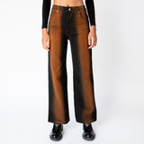 Front close up view of the Eckhaus Latta wide leg jeans in ozone, featuring a vertical stripe of rust brown that gradients to black along the sides of the leg.