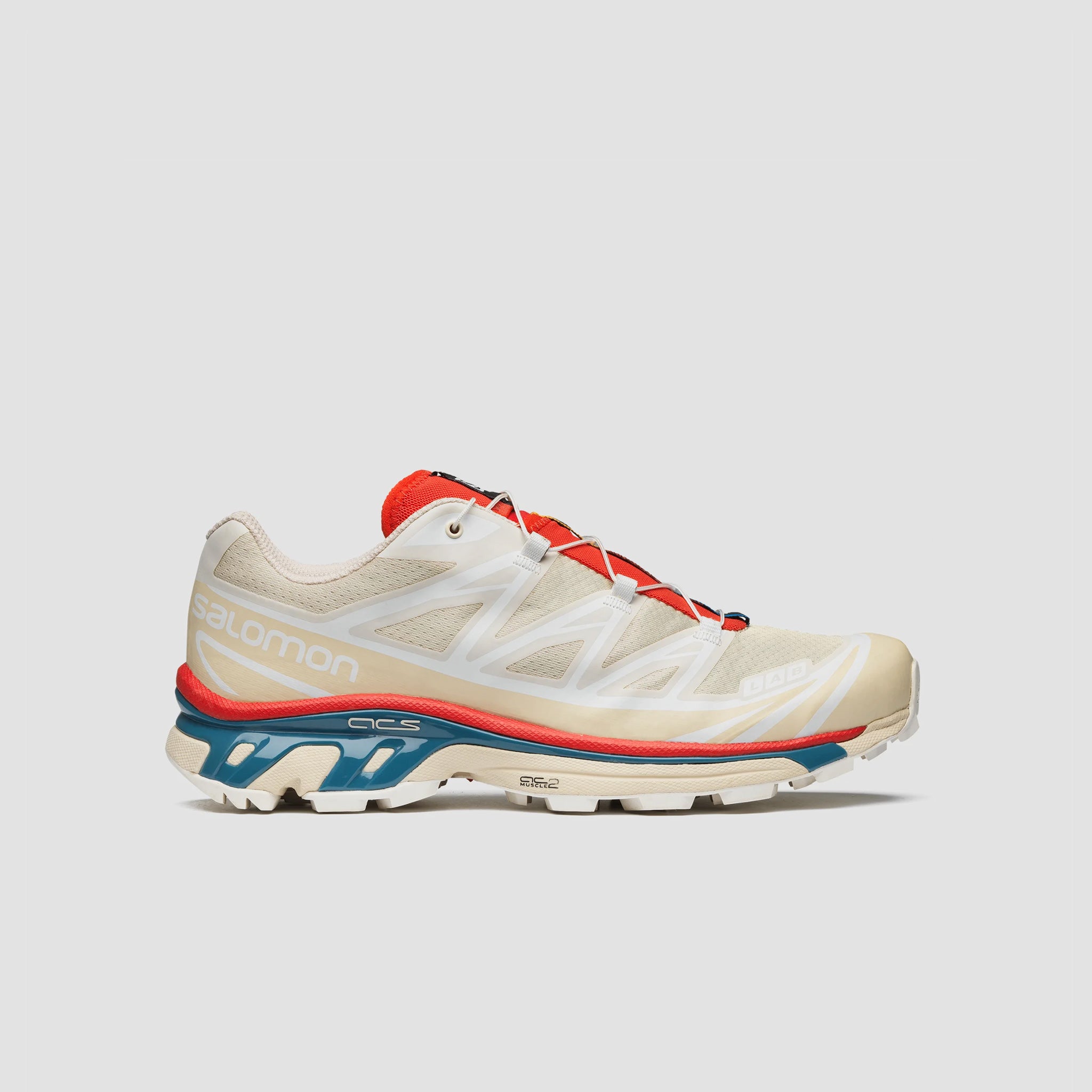Off white XT-6 Salomon Sneakers with vibrant red and teal blue sole details, side view.