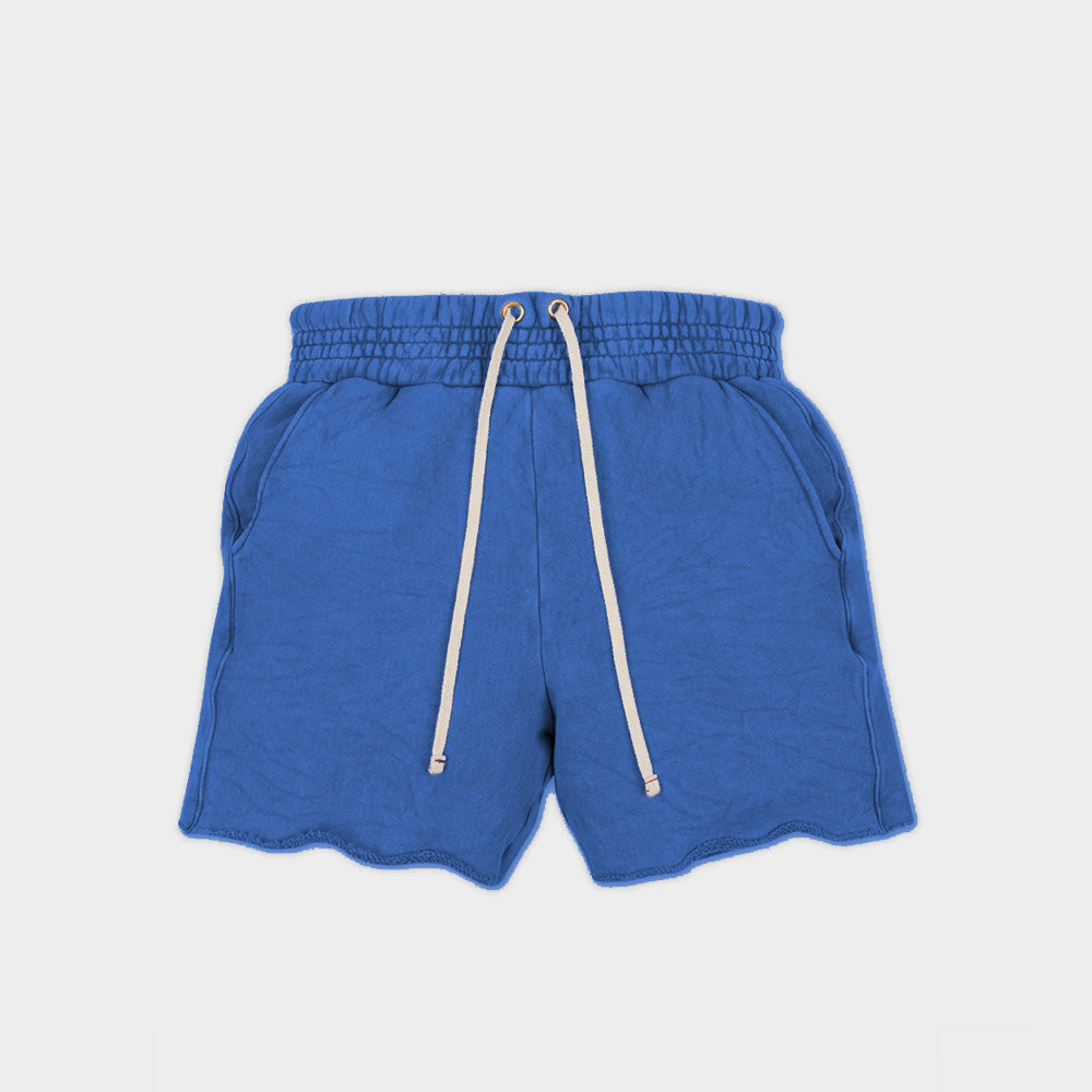 Flat photo of the electric blue cotton Yacht Short by Les Tien, featuring a wide elastic waistband and long white waist ties and side pockets.