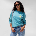 Close detail photo of model wearing the Vintage Washed LCD10 Long Sleeve Graphic Tee - Teal.
