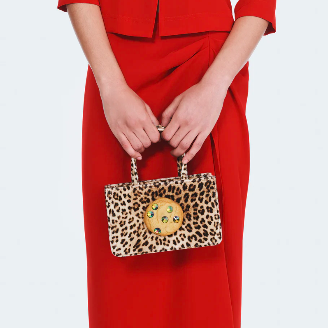 Close detail photo of model wearing the Small Cookie Bag - Leopard Velvet.