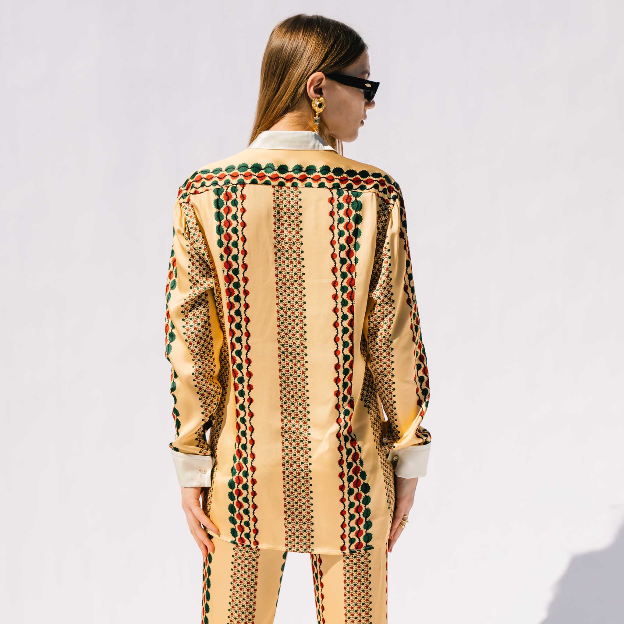 Back half body photo of model wearing the Acoustic Top.