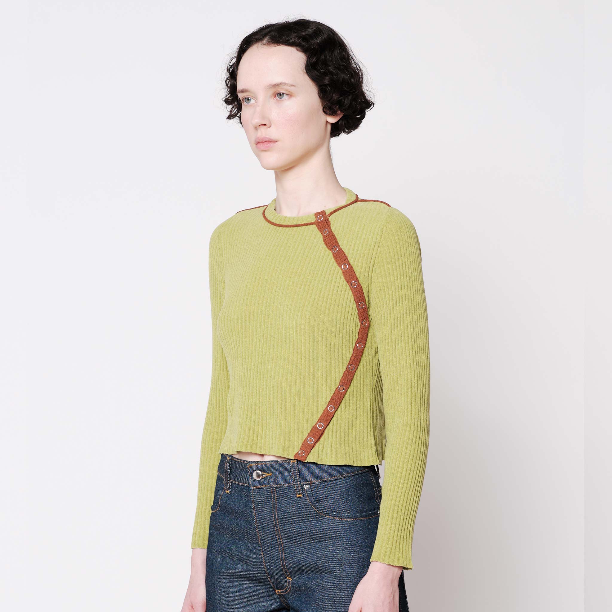 Side half body photo of model wearing the Angle Cardigan - Lime.