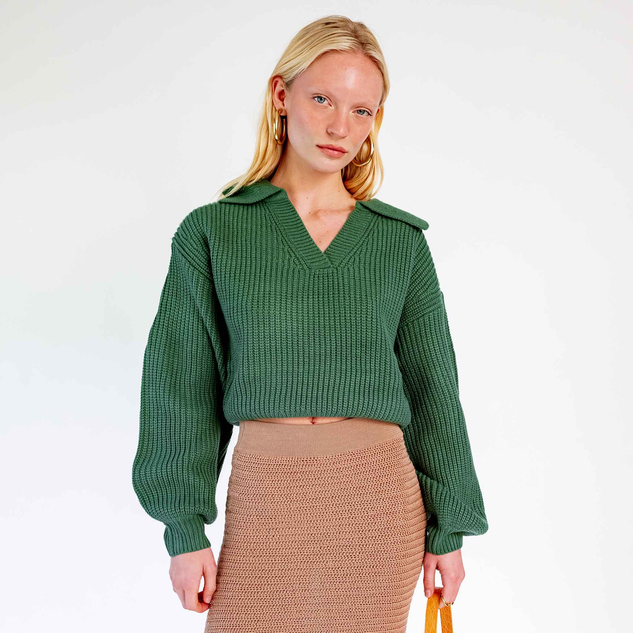 Close half body photo of model wearing the Balloon Sleeve V-Neck Sweater - Green.