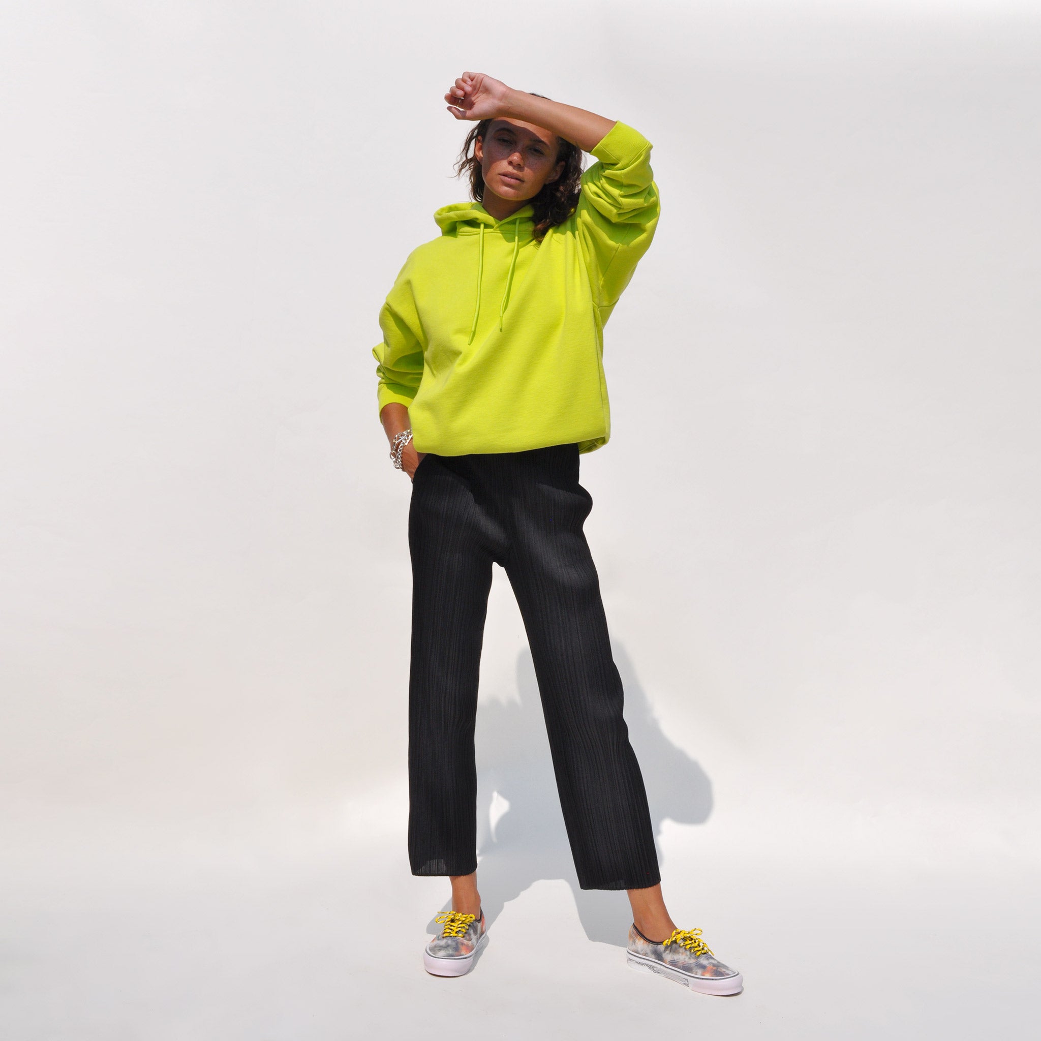 Full shot of model wearing Basics Slim Pants in black by Pleats Please.