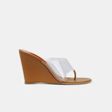 Side view of a high heel wedge sandal with clear PVC upper and thong detail, in toffee brown vegan leather.