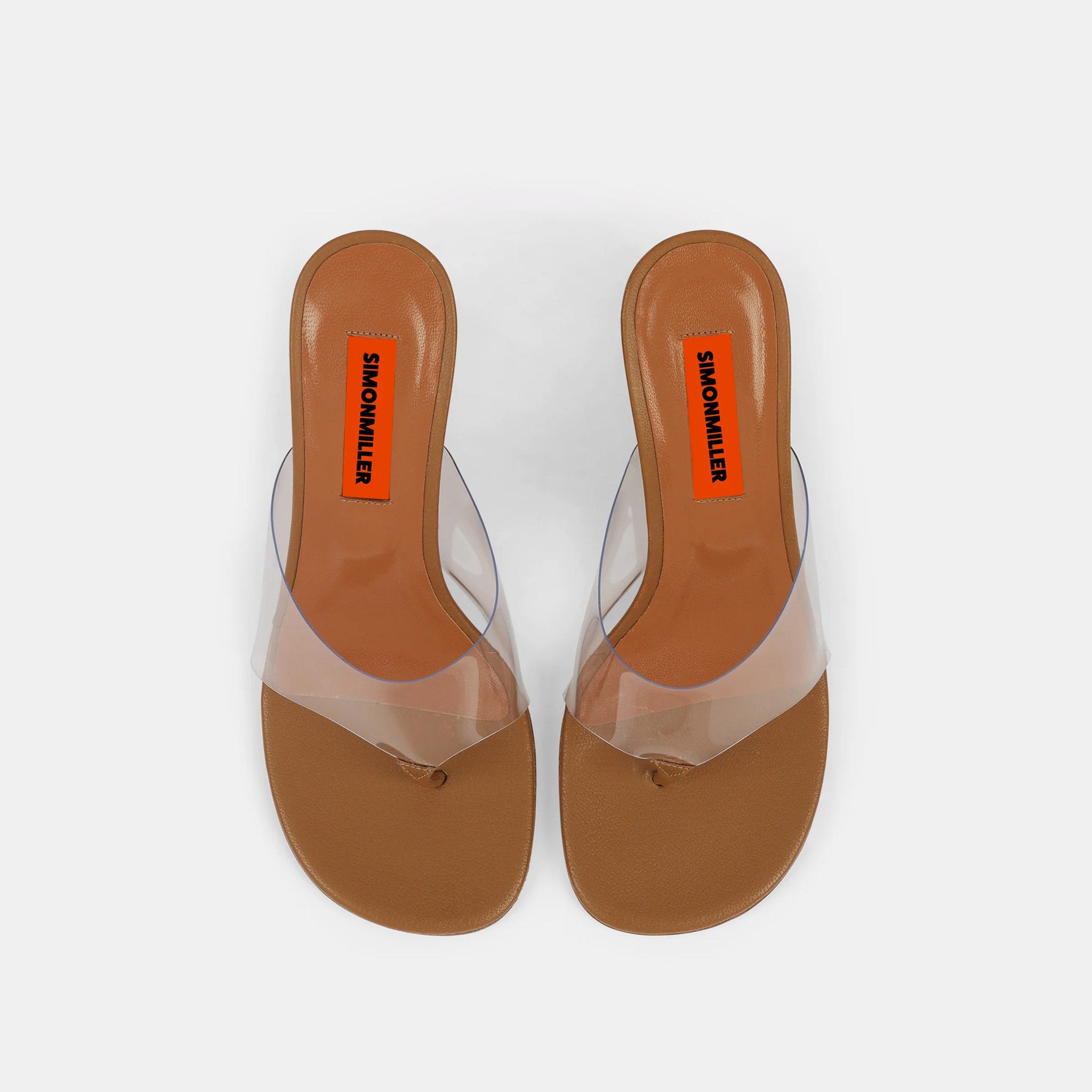 Top down view of a high heel wedge sandal with clear PVC upper and thong detail, in toffee brown vegan leather.