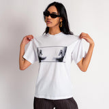 A model wears the white Aries Boobs short sleeve t-shirt featuring a black and white photo print of covered breasts.