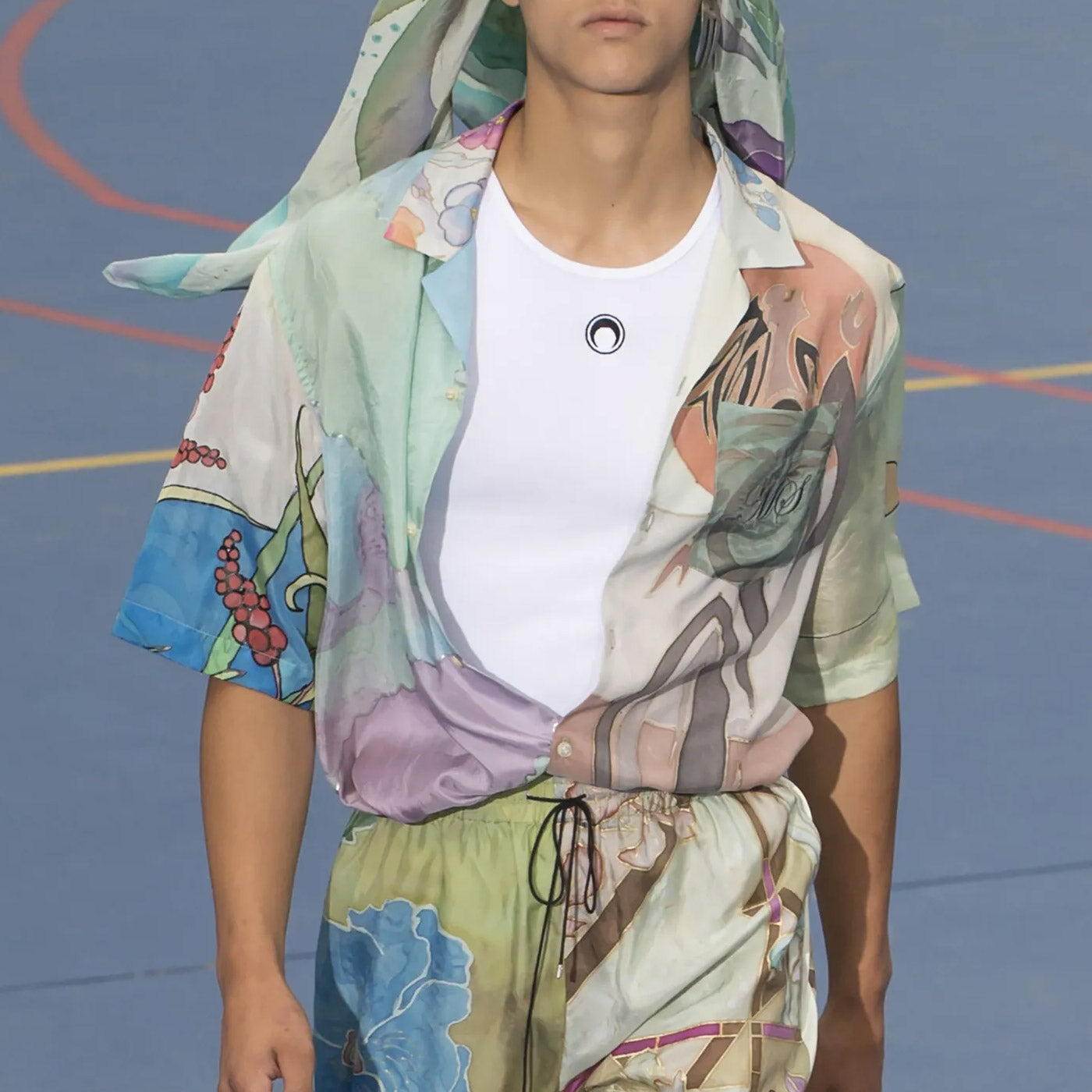 A silk bowling shirt created from multiple vintage scarves and overdyed in a seafoam green - runway sample .