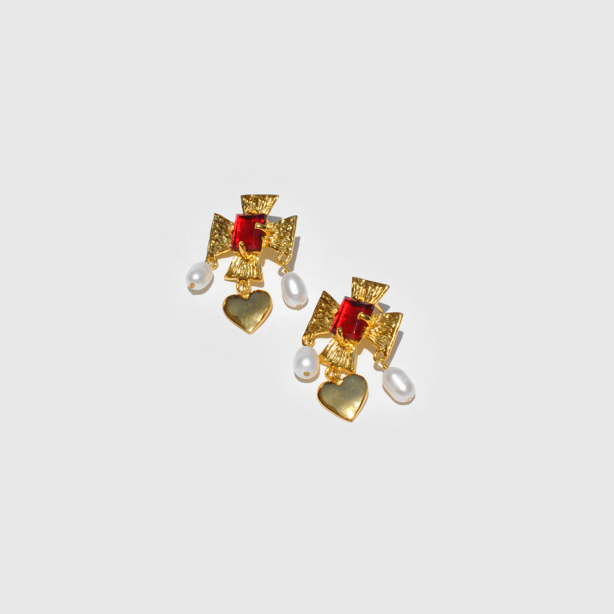 Photograph of the Mondo Mondo Cardinal Earrings in Ruby and gold.