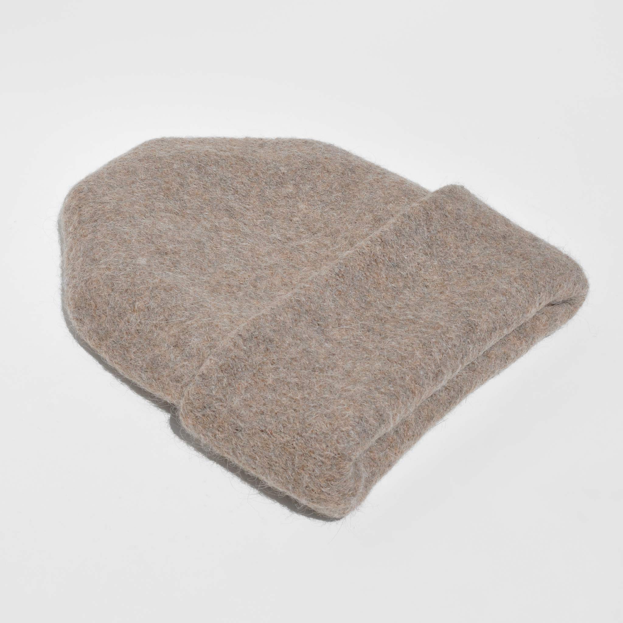 Lauren Manoogian - Carpenter Hat - Driftwood, side view. Photo displays cream oversized beanie laying on white backdrop.