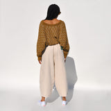 Back photo of a model wearing the chef pants in white flour by Meals.