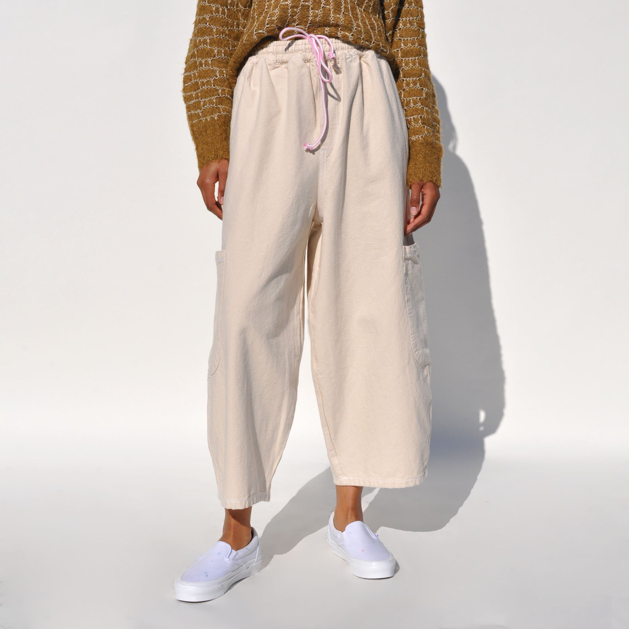 Close up photo of a model wearing the chef pants in white flour by Meals.