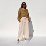 Photo of a model wearing the chef pants in white flour by Meals.