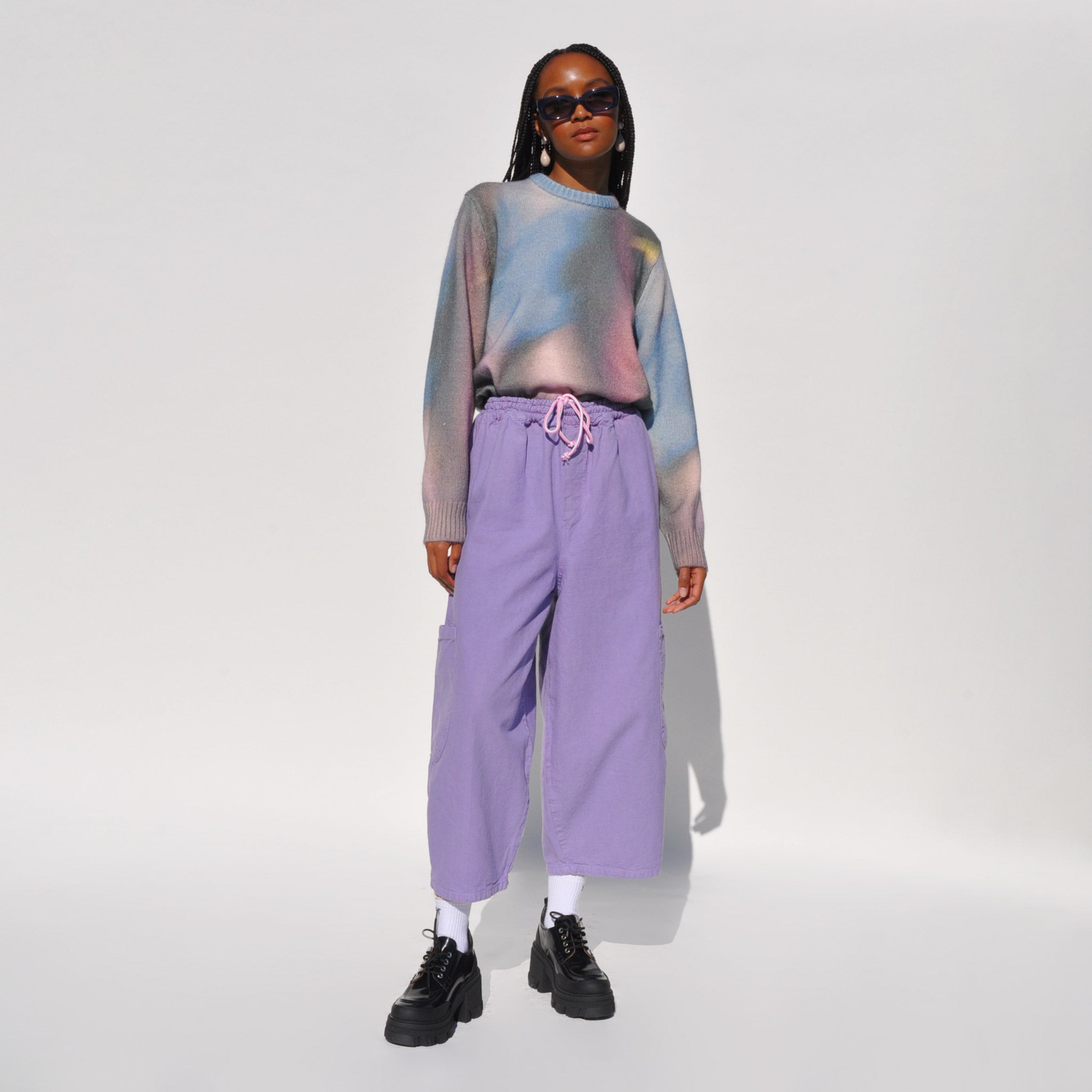 Photo of a model wearing the chef pants in lavender by Meals.