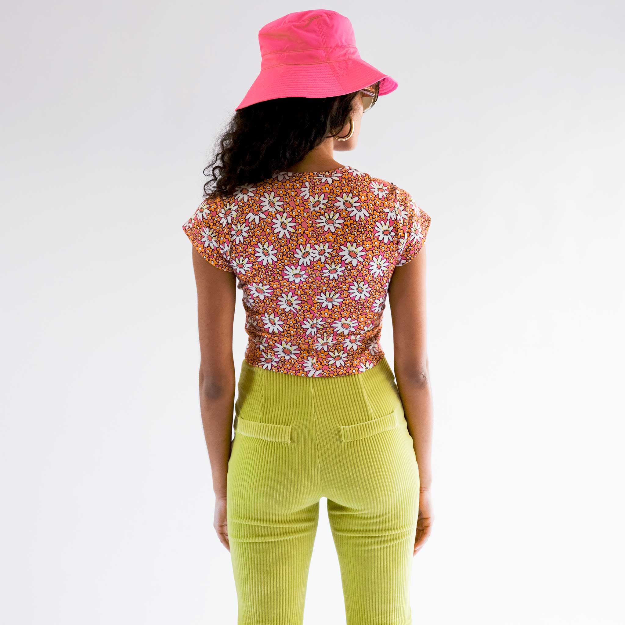 Back half body photo of model wearing the Collina Tee - Hi-Liter Floral.