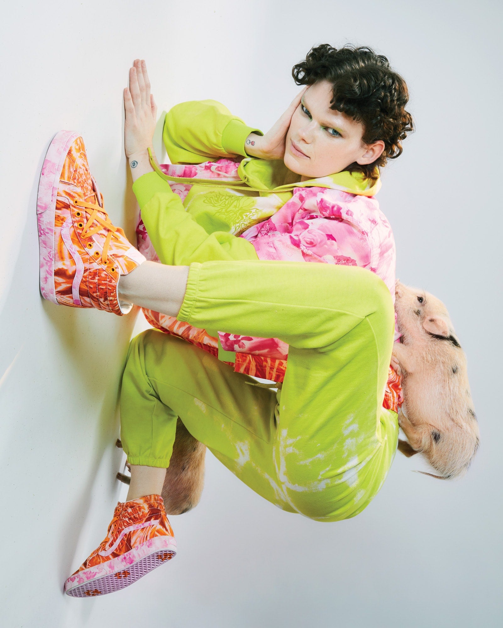 Photo of model with a pig on her back wearing the Van x Collina strada collab.