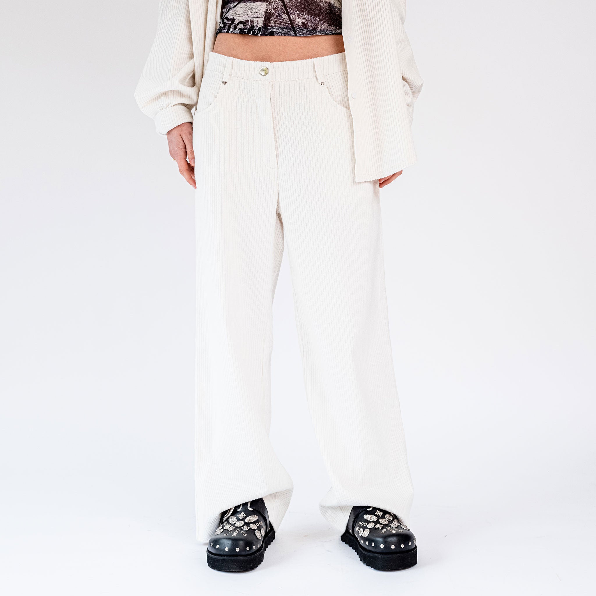 Close half body photo of model wearing the Corduroy Wide Leg Pants - Powder.