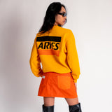Back view of a model wearing the yellow Aries Credit Card sweatshirt with a large back graphic.