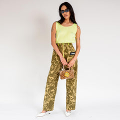 Full outfit photo of a model wearing the unisex Aries Crinkle Camo Walking Trouser, with fluorescent yellow zipper detail and belt loops.