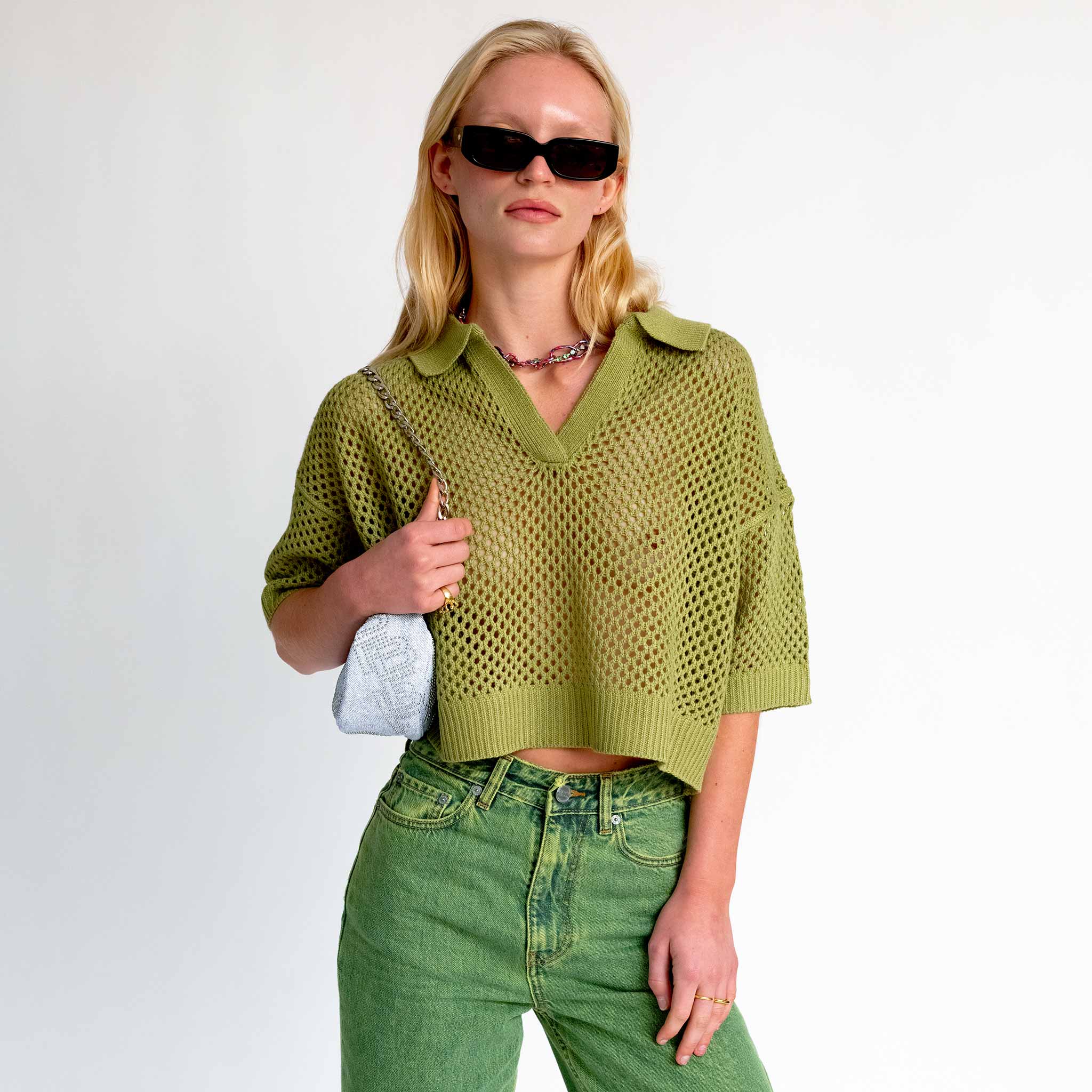 Close detail photo of model wearing the Crochet Polo Top - Leaf. 