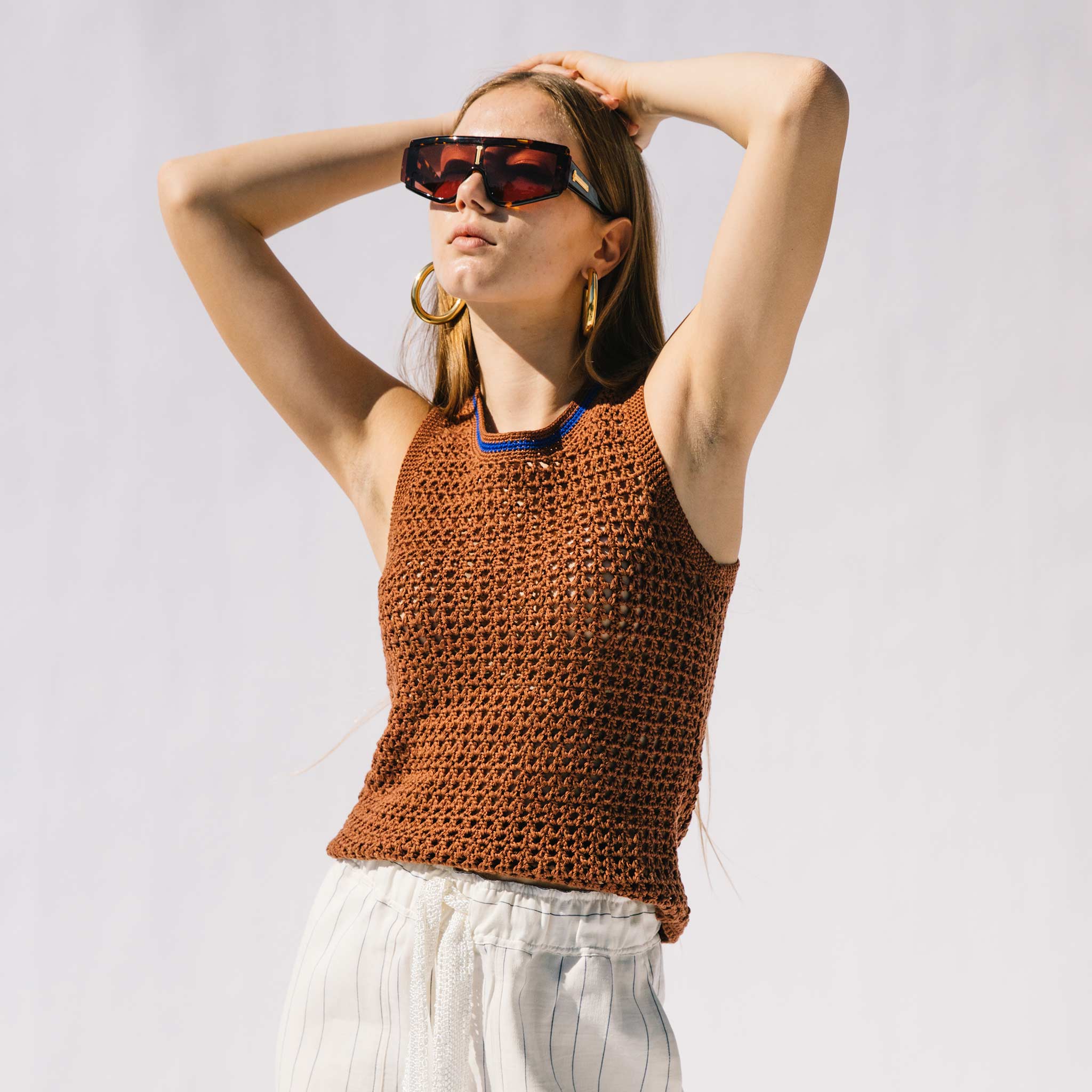 Close half body photo of model wearing the Dance Crochet Vest.