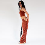 Side full body photo of model wearing the Elshadai Skirt.