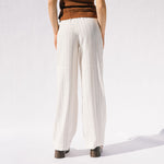 Back half body photo of model wearing the Eternal Trousers - Ivory.