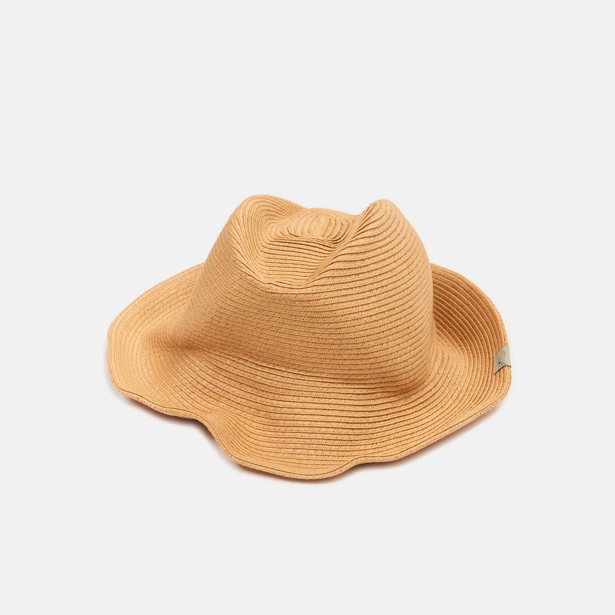 Flat photo showing a tan warped hat with a tonal concentric circle design that mimics a vinyl record's grooves.
