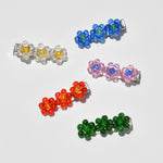Floral Barettes available at LCD. Flower barettes of various colors displayed on white backdrop.