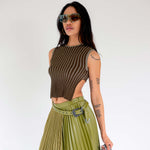 Half body photo of model wearing the Fluted Tank - Lichen. a cropped ribbed knit tank with cutout back detail.