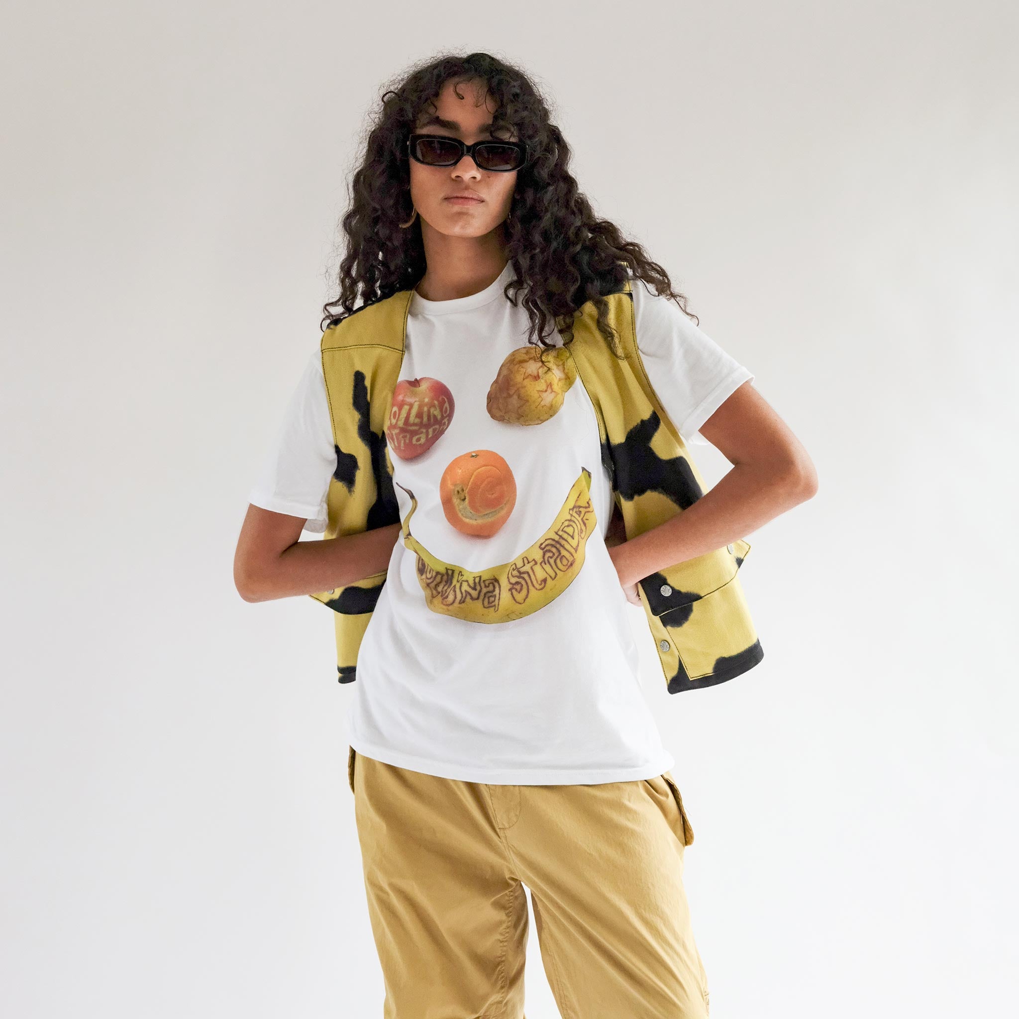 Close half body photo of model wearing the Fruit Tee - Banana Smiley.