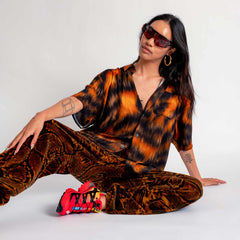 A model sitting down wearing the Stussy Printed S/S Shirt