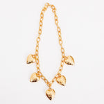 Close flat photo of model wearing the Heart Burn Necklace.