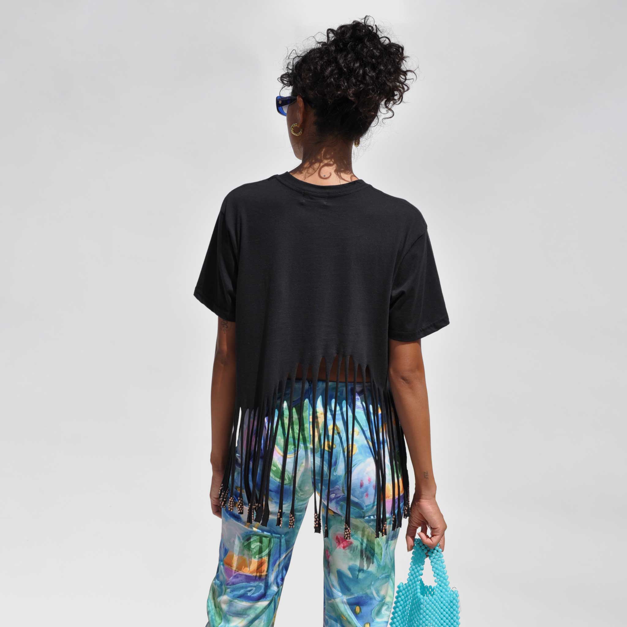 Back detail photo of model wearing the Homecoming Tee - Black