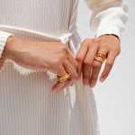 Close detailed photo of models hands wearing the hurly burly ring. 