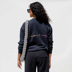Back detail photo of a model wearing the Vintage Washed LCD10 Motto Crewneck. 
