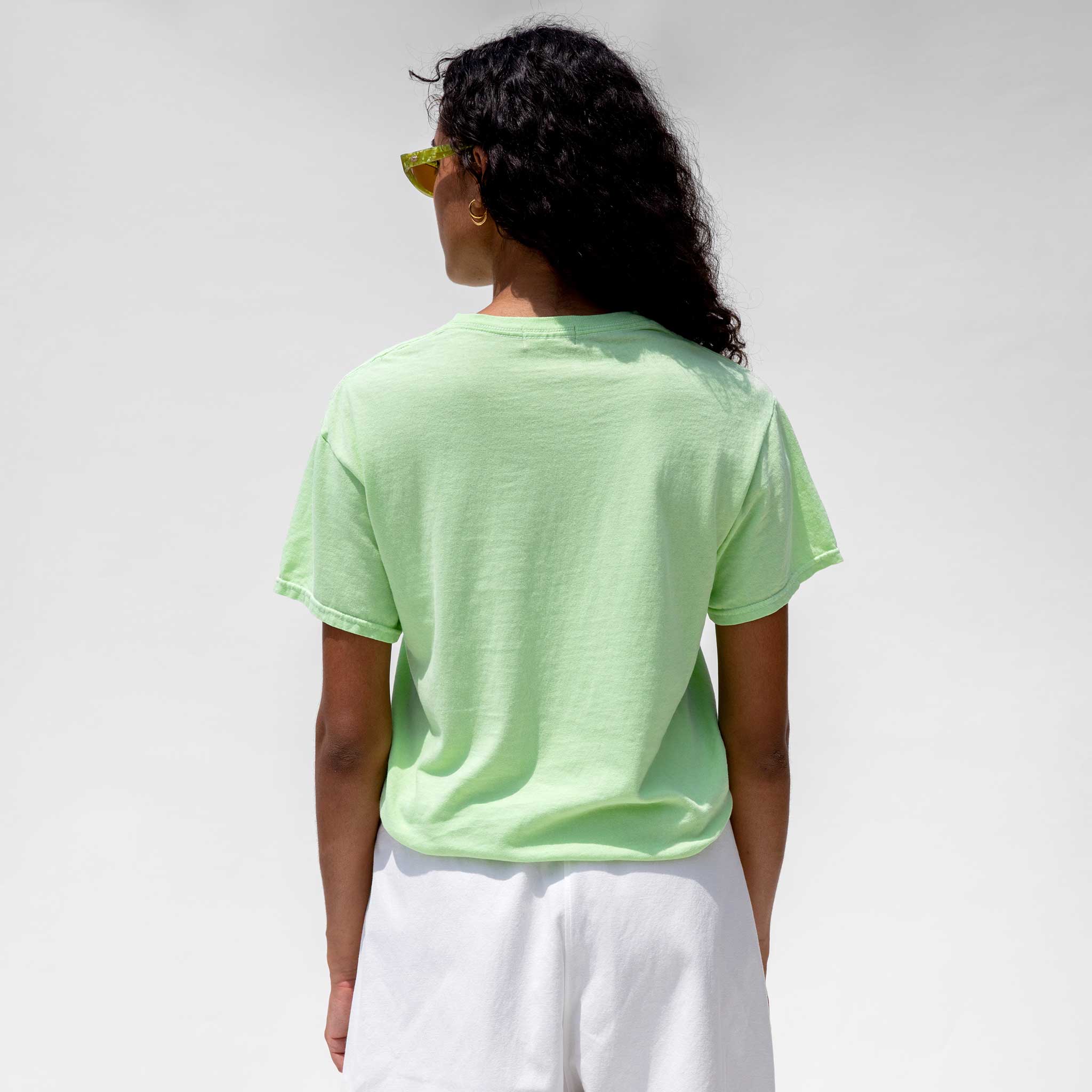Back close photo of model wearing the Vintage Washed LCD10 Short Sleeve Motto Tee - Green, 