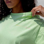 Close detail photo of model wearing the Vintage Washed LCD10 Short Sleeve Motto Tee - Green, showing the graphic. 