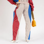 Bak half body photo of model wearing the Idi Track Pant - Beige.