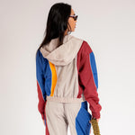 Back half body photo of model wearing the Idi Track Top - Beige.