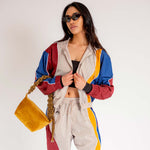 Close half body photo of model wearing the Idi Track Top - Beige.