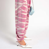 Leg detail view of the pink and white tie dyed velour Juicy Sweatpants with rhinestone embellishments.