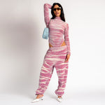 Full outfit view of the pink and white tie dyed velour Juicy Sweatpants with rhinestone embellishments.