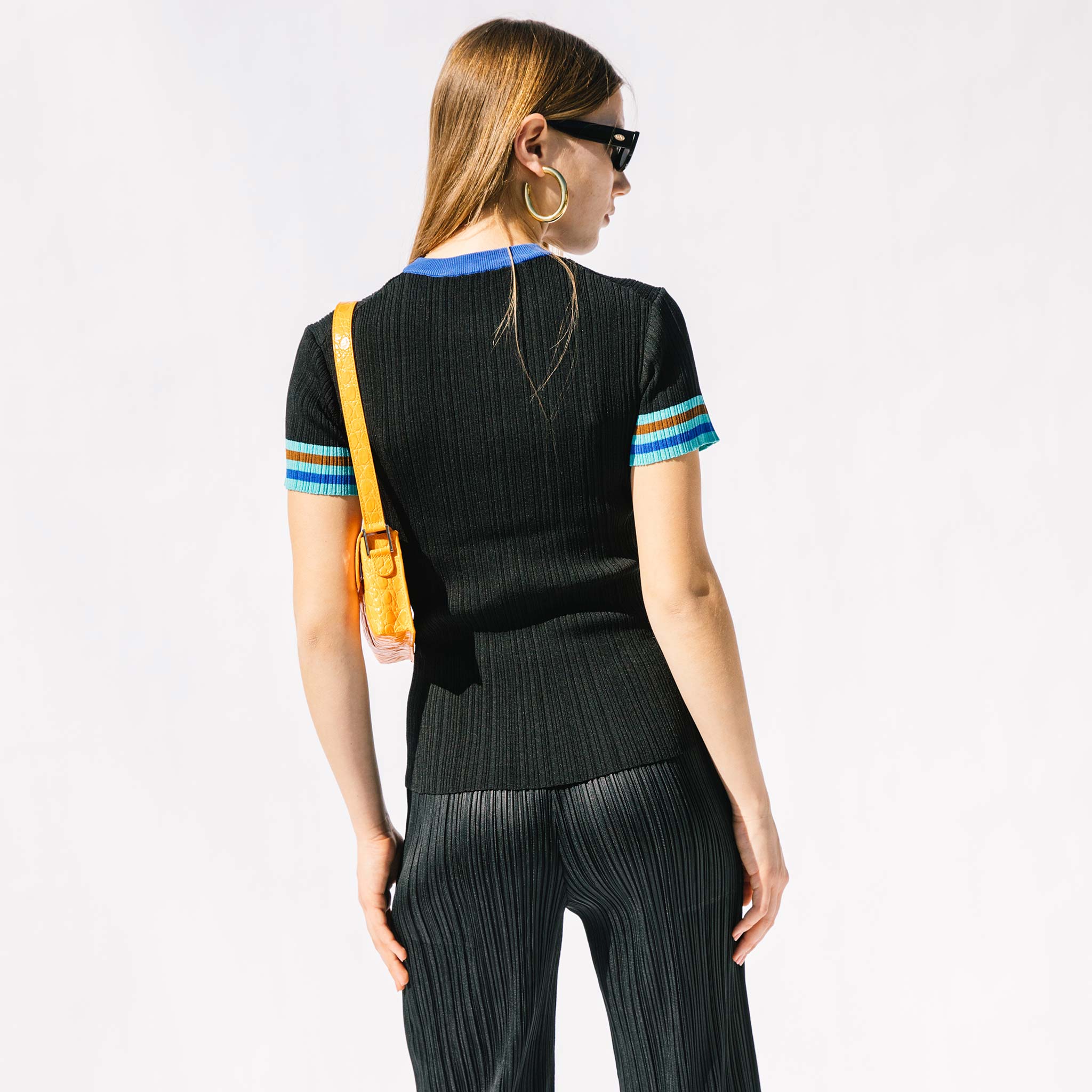 Back half body photo of model wearing the Knit Top.