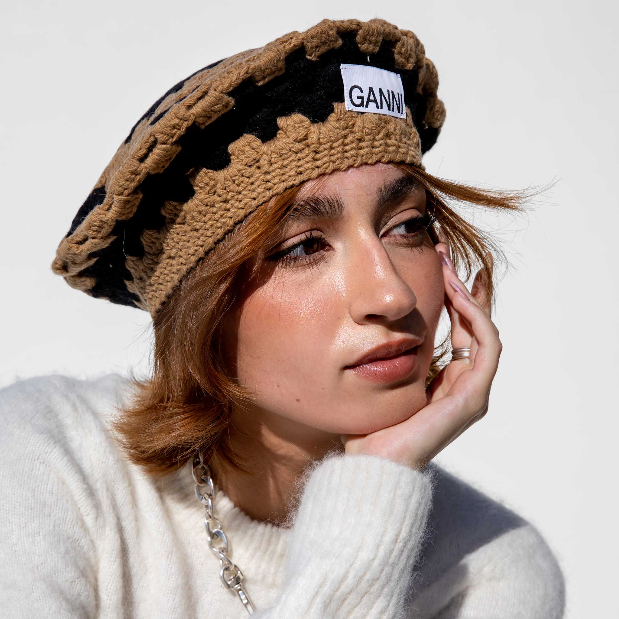 Front close detail photo of model wearing the Lambswool Crochet Striped Beret.