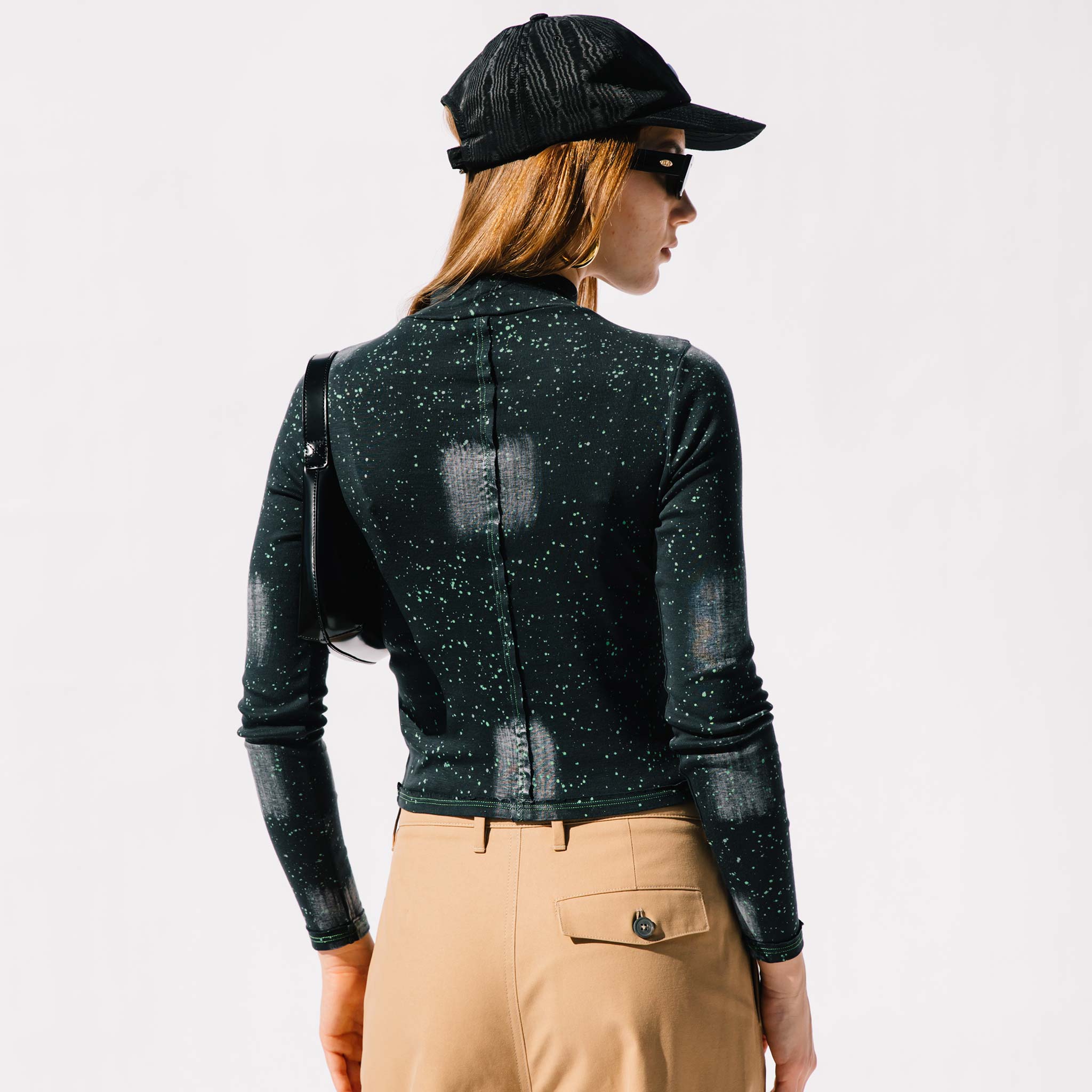 Back half body photo of model wearing the Lapped Baby Tee - Laser .