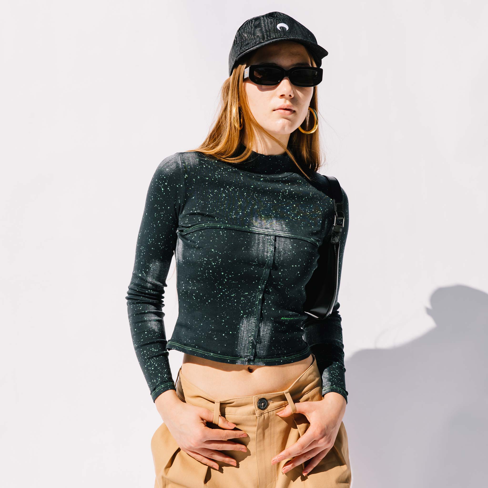 Close half body photo of model wearing the Lapped Baby Tee - Laser.