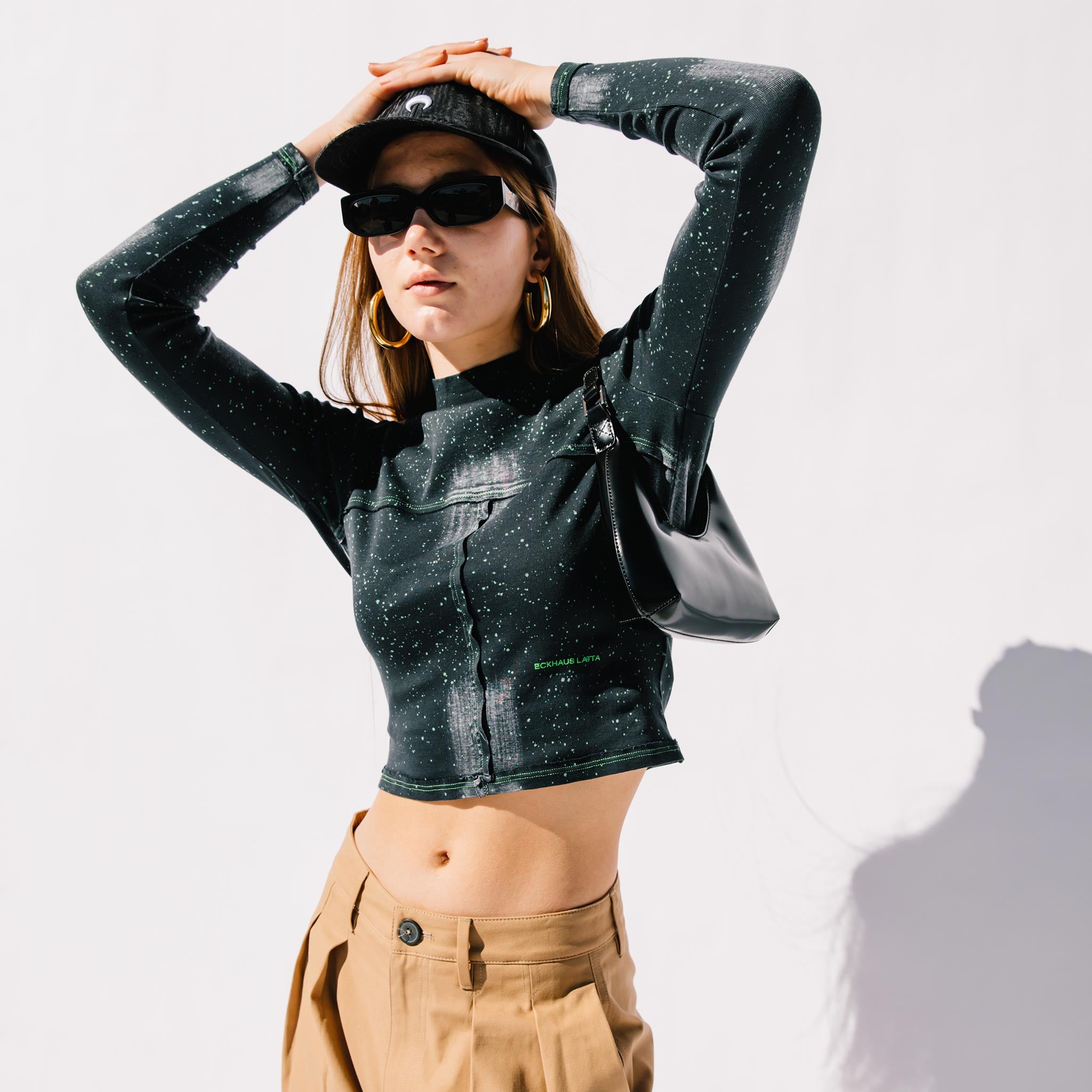Close half body photo of model wearing the Lapped Baby Tee - Laser .