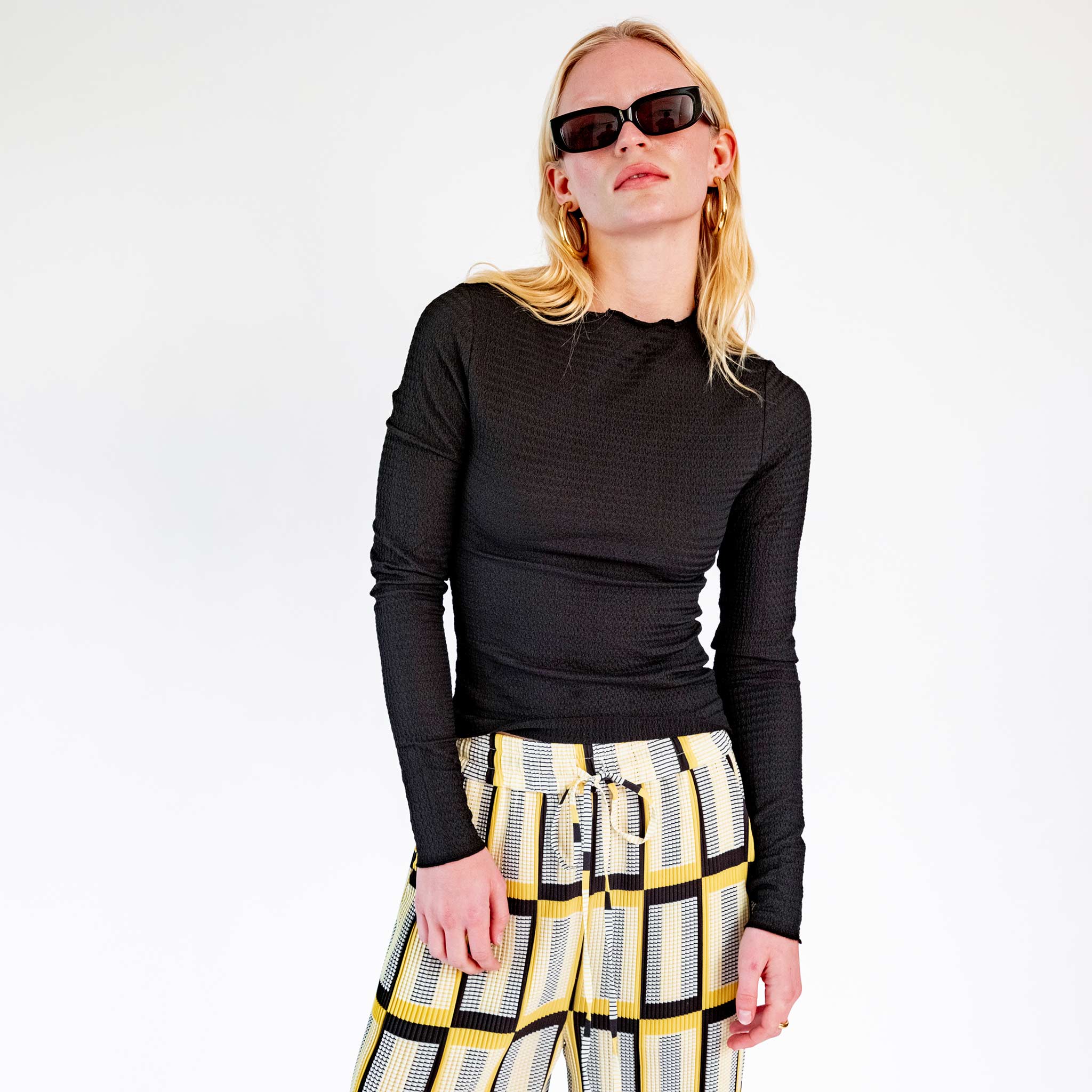 Close half body photo of model wearing the Lettuce Hem Longsleeve - Black.